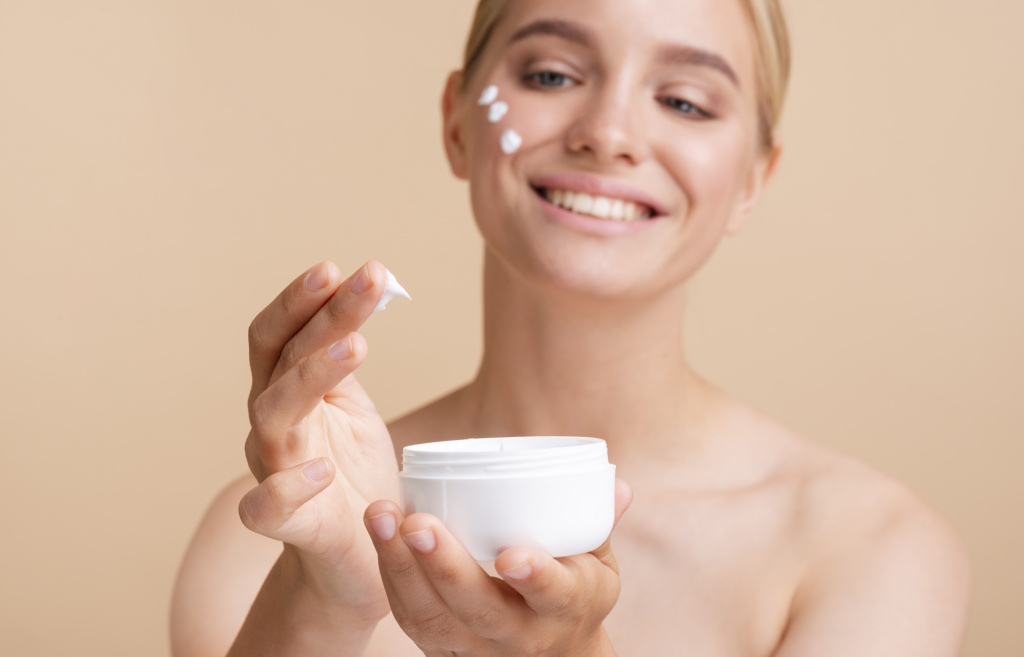 close-up-blonde-woman-with-face-cream-and-jar.jpg