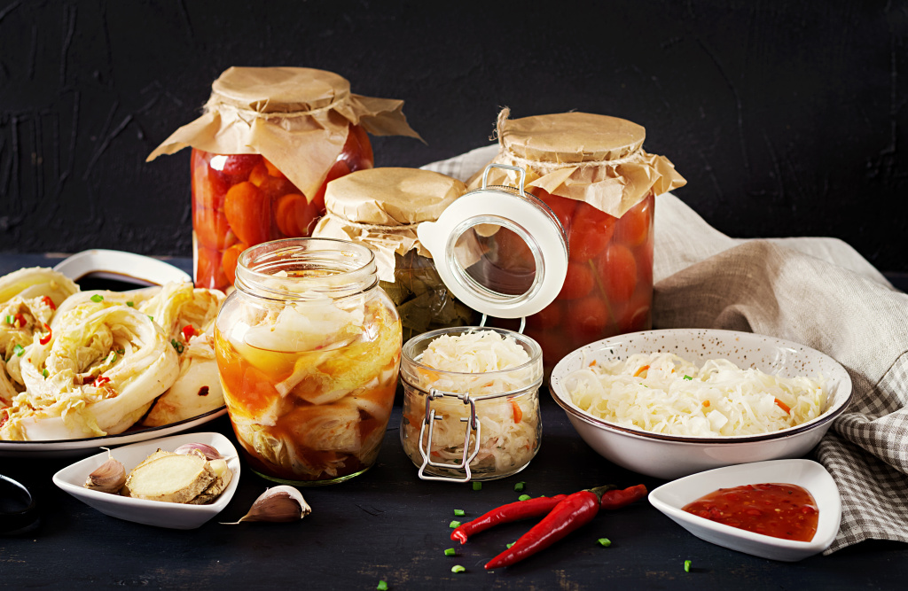 cabbage-kimchi-tomatoes-marinated-sauerkraut-sour-glass-jars-over-rustic-kitchen-table.jpg
